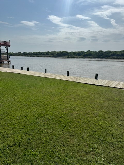2031 Beach Road Matagorda, TX 77457 - Photo 3 of 4 a view of a lake with houses in background