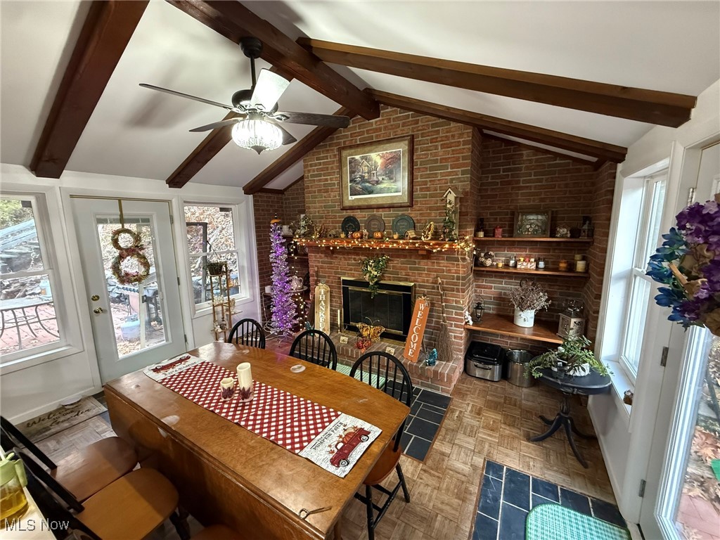 8116 Deer Road Southwest Bowerston, OH 44695 - Photo 15 of 49 Dining room featuring a brick fireplace and a ceiling fan