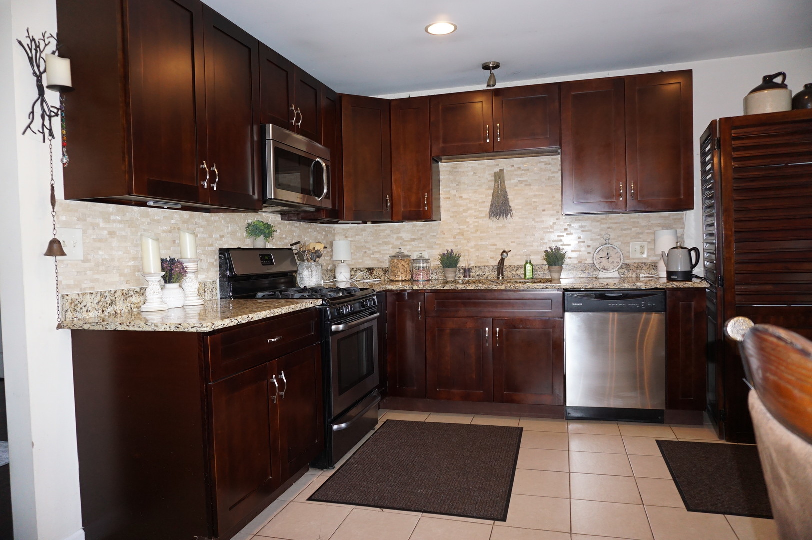 221 Healy Avenue Romeoville, IL 60446 - Photo 2 of 13 a kitchen with stainless steel appliances granite countertop a sink stove and microwave