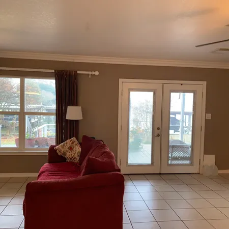 a living room with furniture and a large window