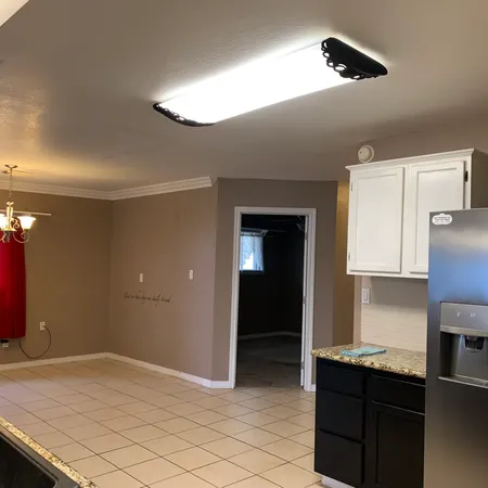 a kitchen with kitchen island stainless steel appliances a sink cabinets and wooden floor