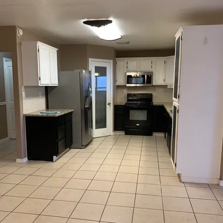a kitchen with stainless steel appliances a sink and a refrigerator
