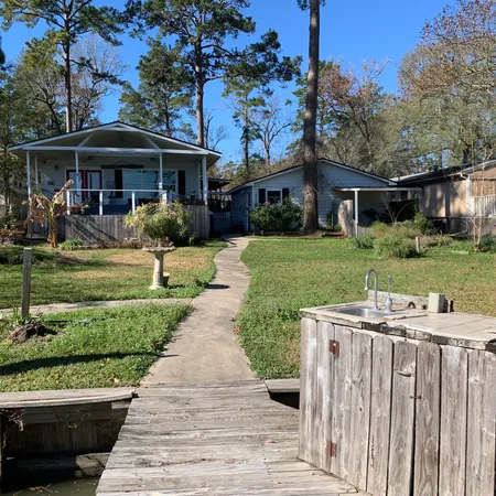 a front view of a house with a yard table and chairs