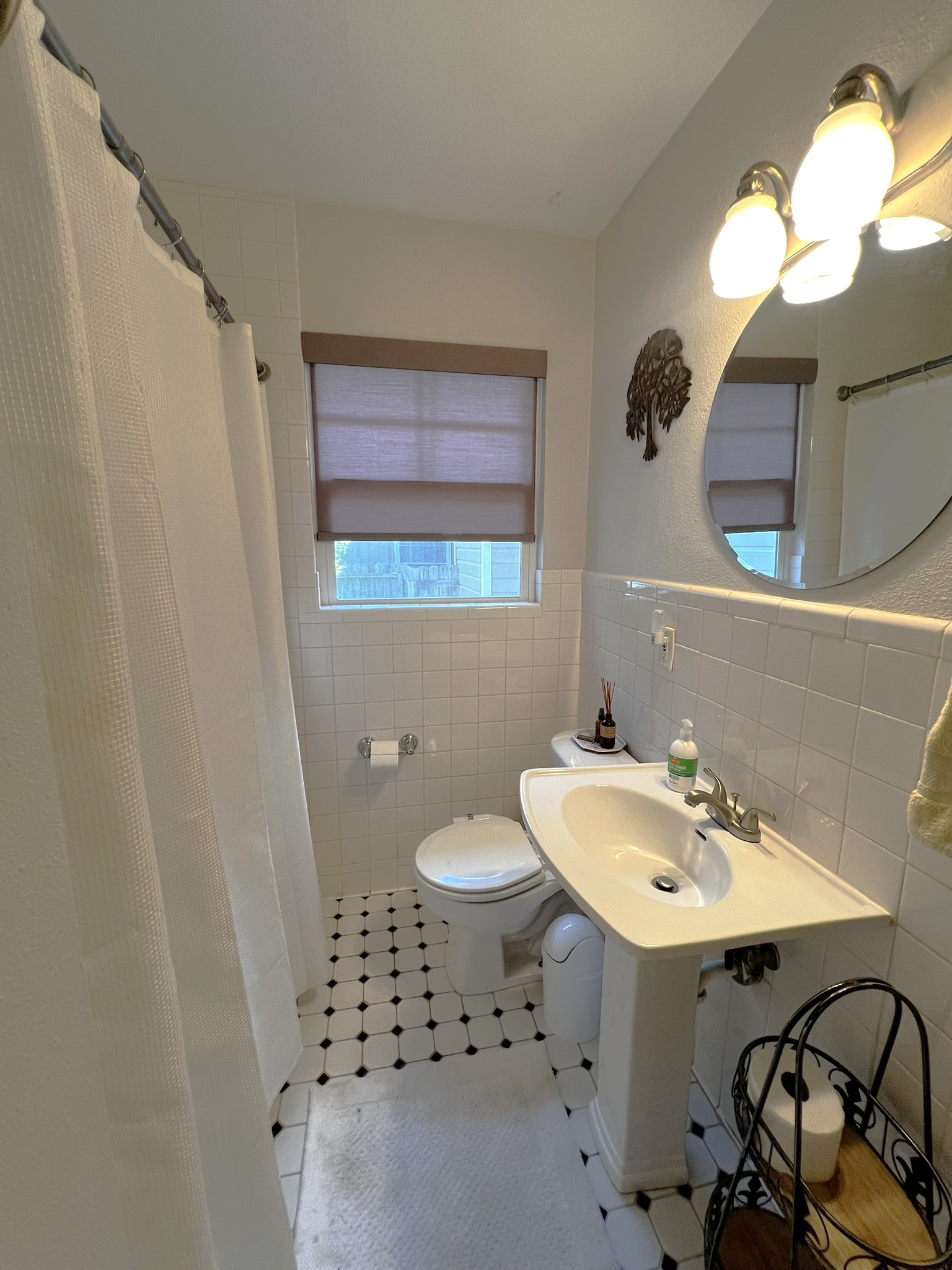 1311 Aggie Lane, Unit A Austin, TX 78757 - Photo 11 of 13 Hall Bathroom featuring tile walls, toilet, tile patterned flooring, wainscoting, and curtained shower