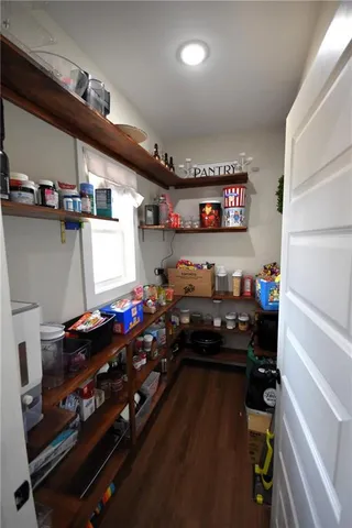 a room with stainless steel appliances lots of different colored cloths