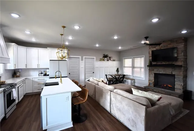 a kitchen with stove a sink and a refrigerator