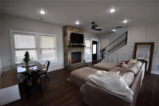 a living room with furniture a flat screen tv and a fireplace