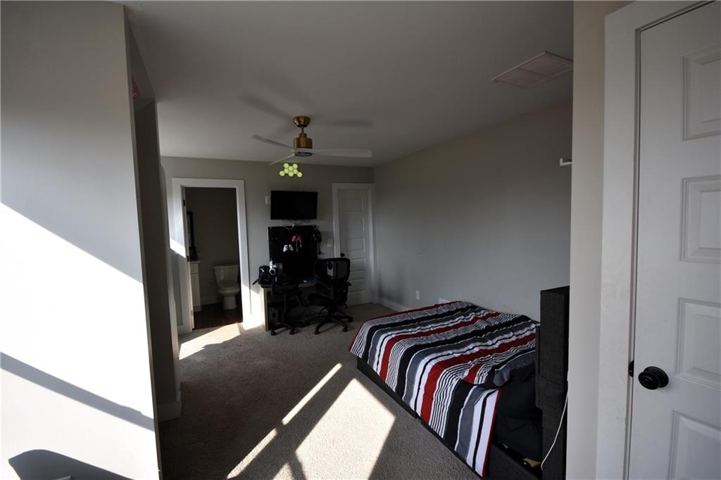 533 Lively Road Waco, GA 30182 - Photo 34 of 41 a view of walk in closet with clothes and shoes