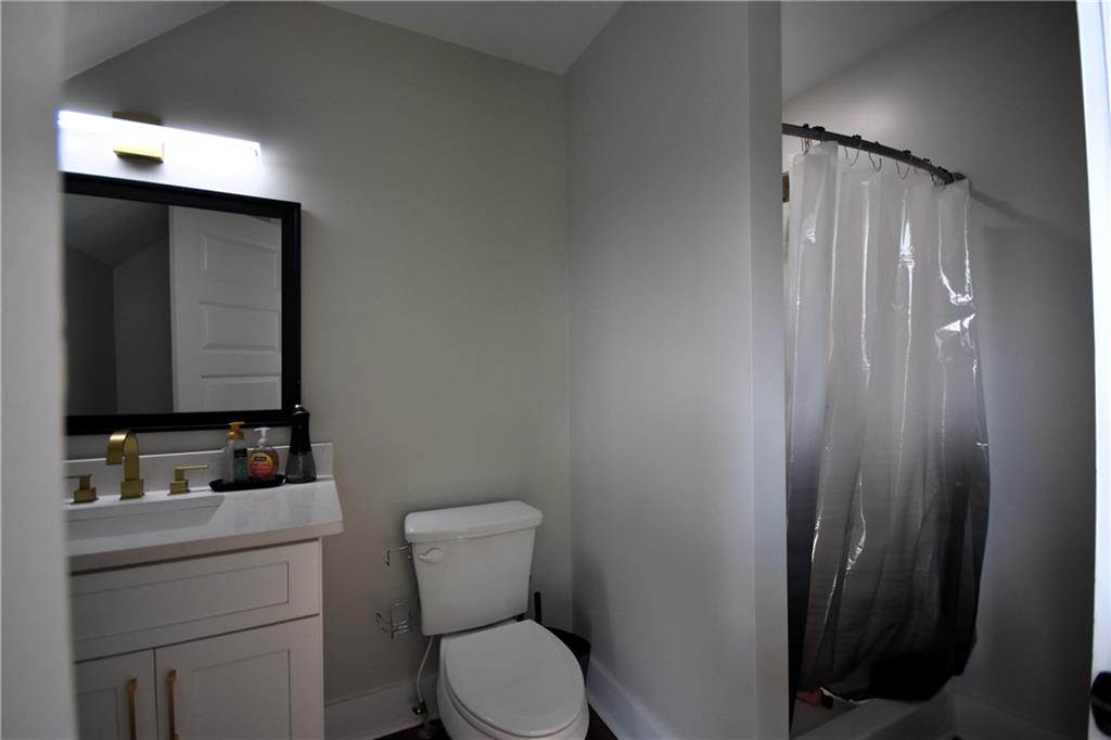 533 Lively Road Waco, GA 30182 - Photo 39 of 41 a bathroom with a toilet sink vanity and mirror