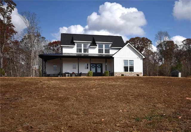 a front view of a house with a garden