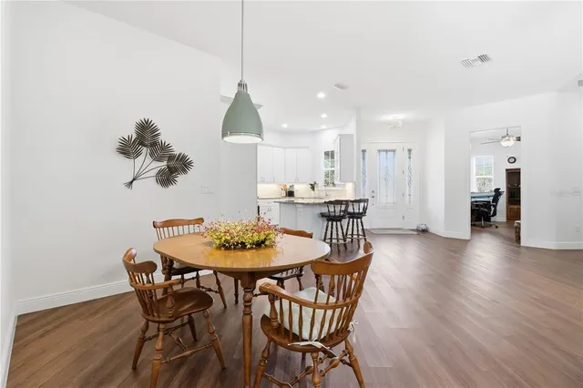 a dining room with furniture and wooden floor