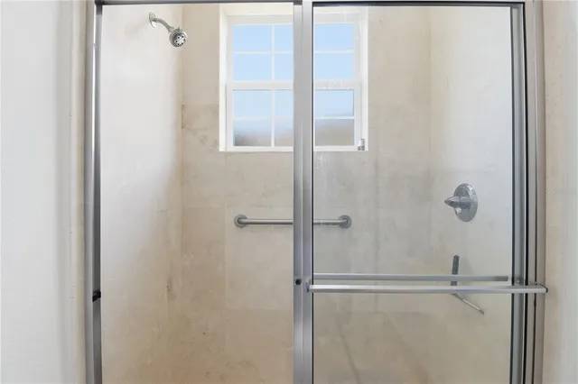 a bathroom with a glass shower door