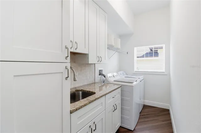 a kitchen with stainless steel appliances granite countertop a sink and a stove with white countertops