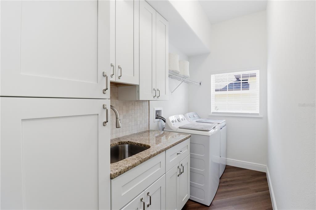 5470 West Hunter Run Lane Homosassa, FL 34446 - Photo 27 of 46 a kitchen with stainless steel appliances granite countertop a sink and a stove with white countertops