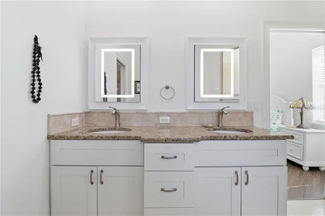 a bathroom with a granite countertop sink and a mirror