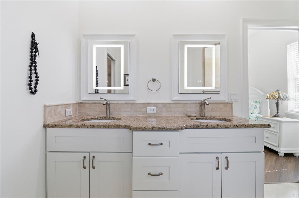 5470 West Hunter Run Lane Homosassa, FL 34446 - Photo 30 of 46 a bathroom with a granite countertop sink and a mirror