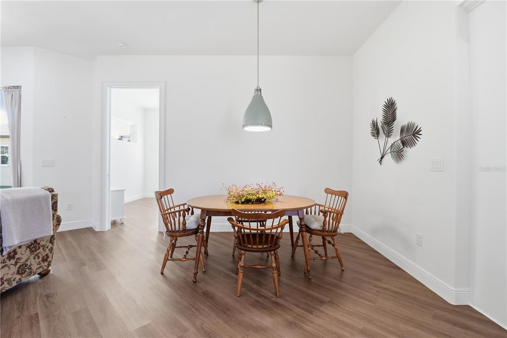5470 West Hunter Run Lane Homosassa, FL 34446 - Photo 9 of 46 a view of a dining room with furniture and wooden floor