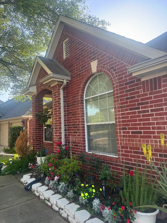 11126 Riverbank Ridge Lane Houston, TX 77089 - Photo 2 of 8 a front view of a house with a garden