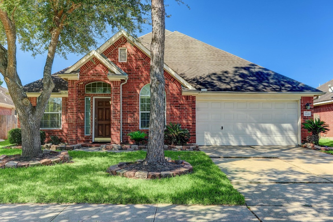 11126 Riverbank Ridge Lane Houston, TX 77089 - Photo 3 of 8 a front view of a house with a yard