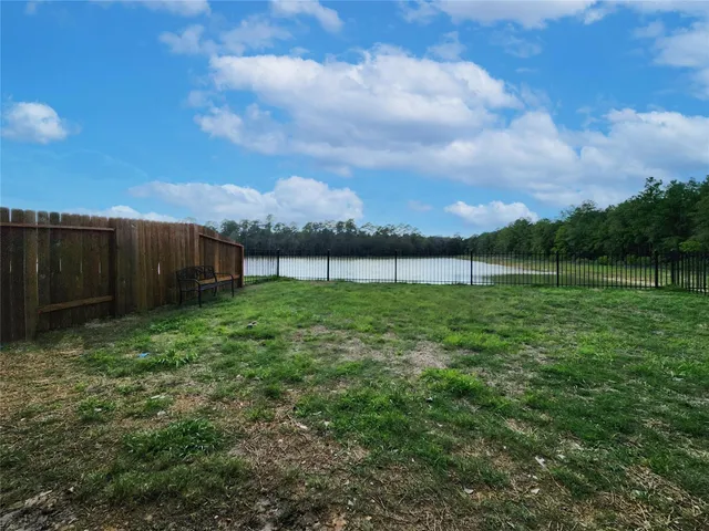 a view of a garden with a wooden fence