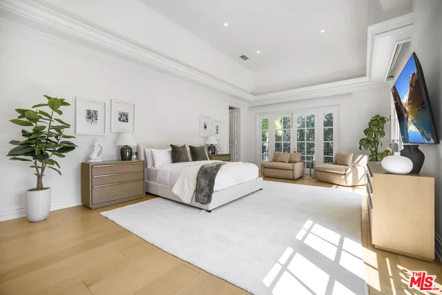 a spacious bathroom with a tub sink and mirror
