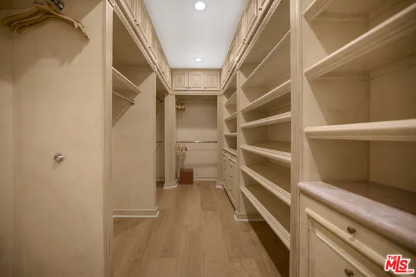 a spacious bedroom with a large bed and a large window