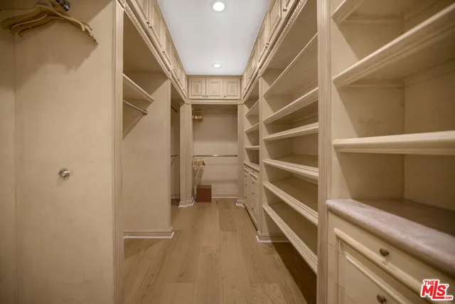 a spacious bedroom with a large bed and a large window