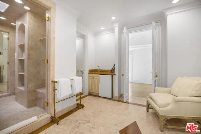 a bathroom with a granite countertop sink a toilet and a mirror