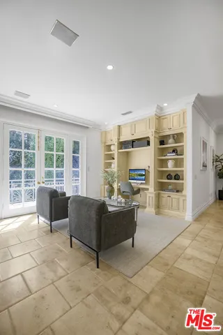 a living room with furniture a fireplace and a chandelier