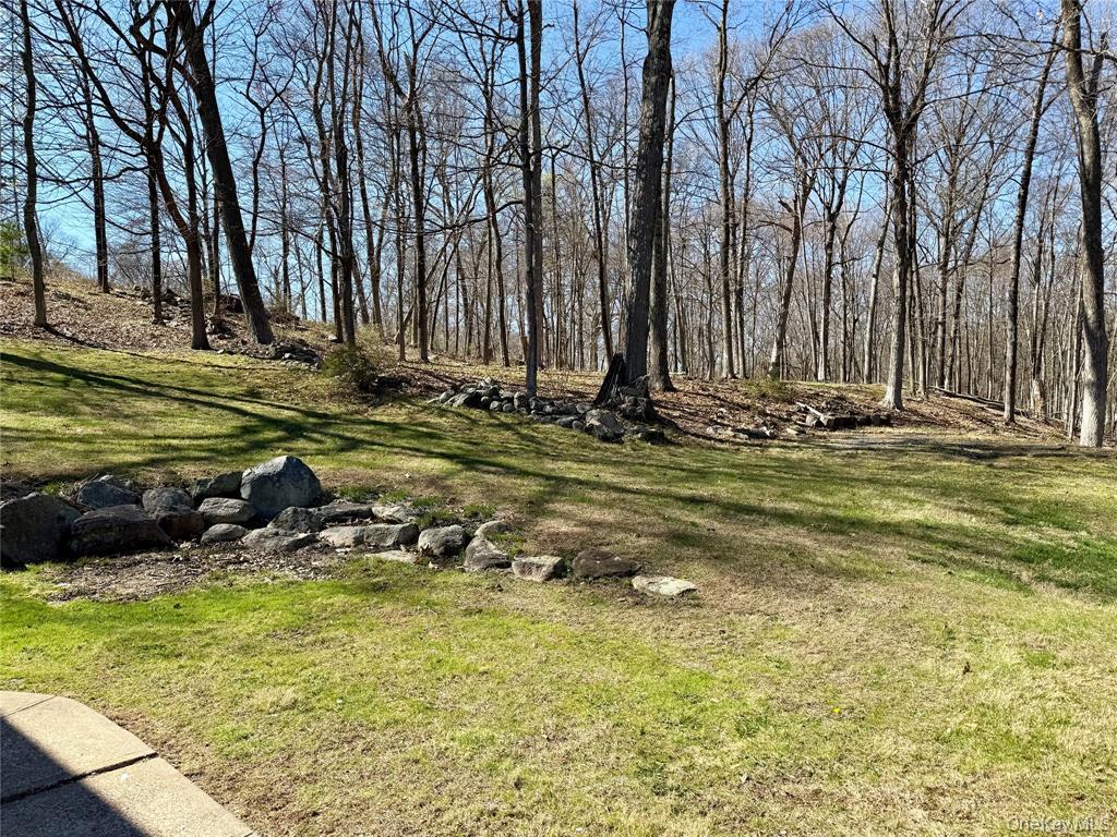 25 Valley Road Pleasantville, NY 10570 - Photo 2 of 10 a view of a swimming pool with lawn chairs under an umbrella