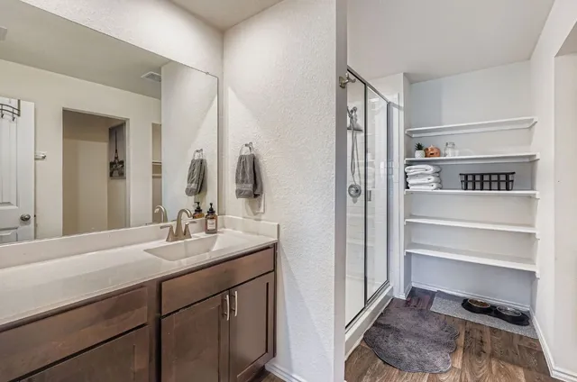 a bathroom with a sink a toilet and shower