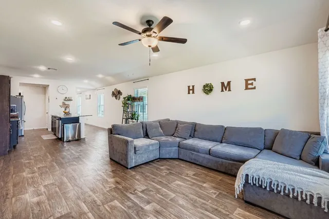 a living room with furniture and kitchen view