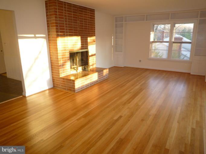 7207 Fort Hunt Road Alexandria, VA 22307 - Photo 1 of 15 wooden floor in an empty room with a window