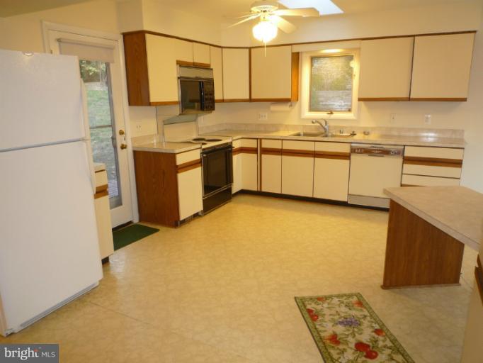 7207 Fort Hunt Road Alexandria, VA 22307 - Photo 14 of 15 a kitchen with stainless steel appliances a sink and a refrigerator