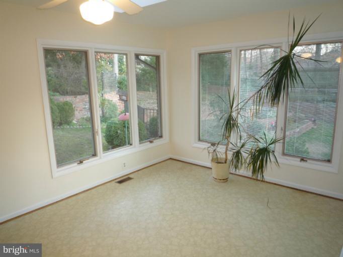 7207 Fort Hunt Road Alexandria, VA 22307 - Photo 7 of 15 an empty room with windows and outdoor view