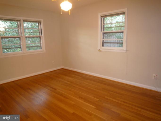7207 Fort Hunt Road Alexandria, VA 22307 - Photo 9 of 15 an empty room with wooden floor and windows