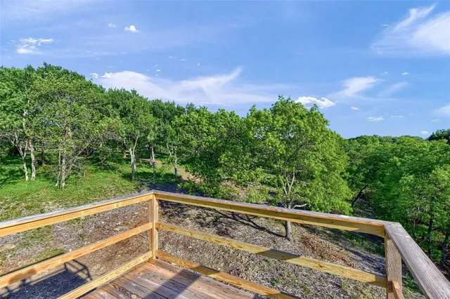 a view of balcony with wooden floor and fence