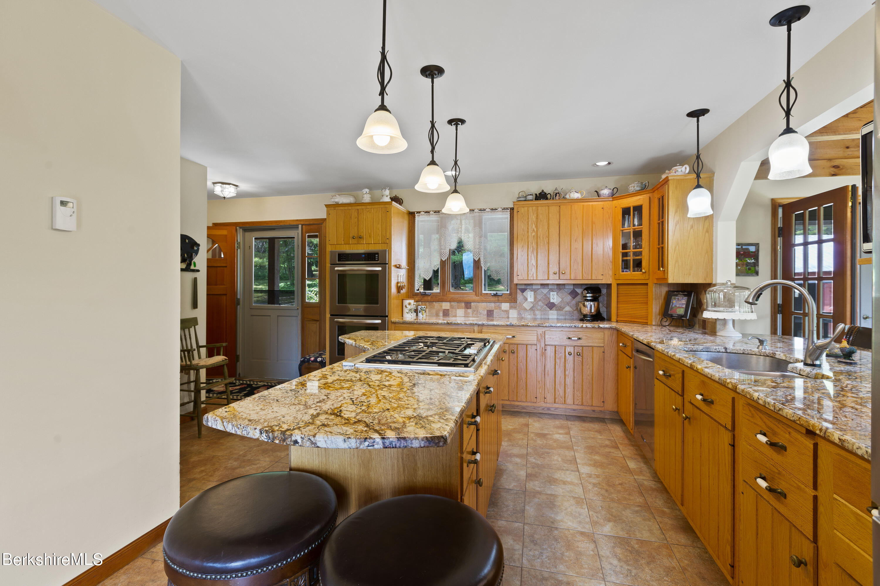 3025 Mt Anthony Road Bennington, VT 05201 - Photo 24 of 54 a kitchen with stainless steel appliances granite countertop a sink and cabinets