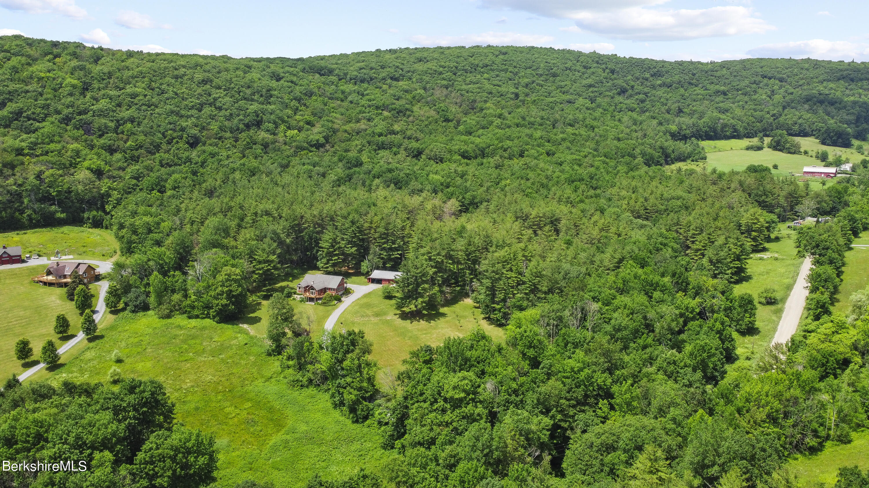 3025 Mt Anthony Road Bennington, VT 05201 - Photo 47 of 54 a view of a house with a lush green forest