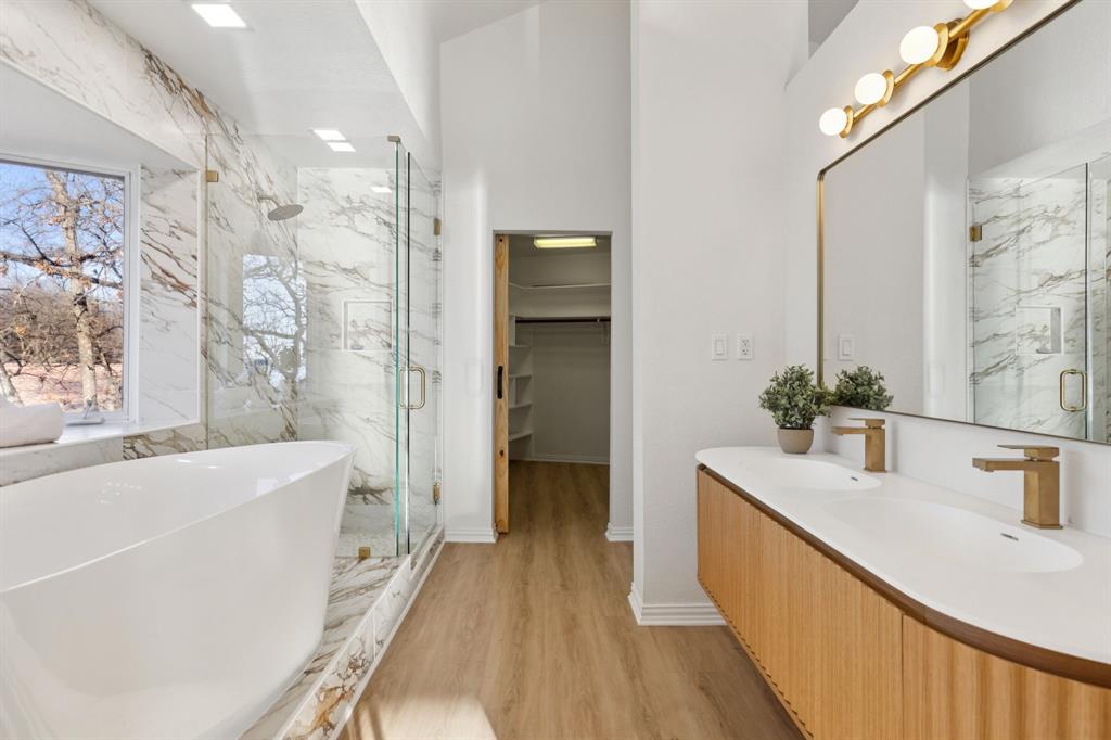 540 Diamond Point Drive Oak Point, TX 75068 - Photo 18 of 27 Bathroom featuring a marble finish shower, double vanity, a freestanding tub, a spacious closet, and light wood-type flooring