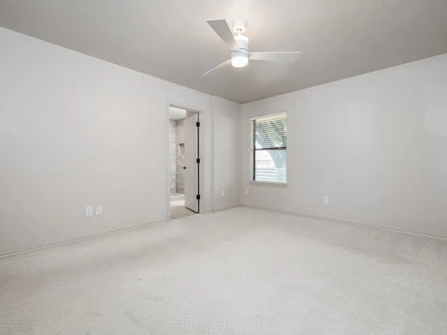 a spacious bathroom with a tub sink and mirror