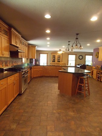 74 Monson Road Brimfield, MA 01010 - Photo 8 of 29 a large kitchen with stainless steel appliances granite countertop a sink and cabinets