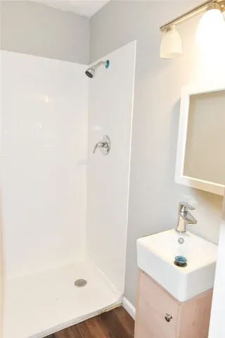 a bathroom with a sink a shower and a mirror