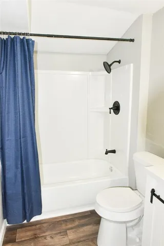 a bathroom with a toilet and a shower