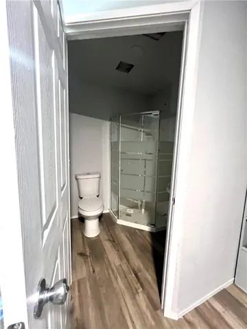 a bathroom with a toilet and a shower
