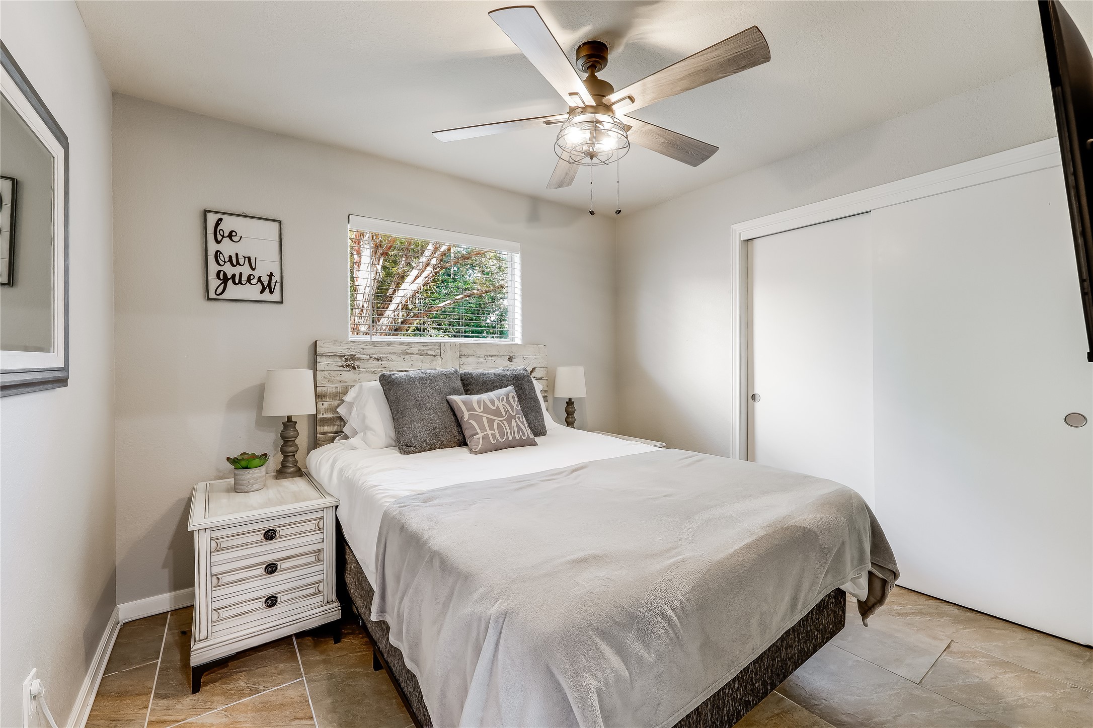 426 Summit Ridge Drive North Point Venture, TX 78645 - Photo 19 of 28 a bedroom with a bed and a chandelier