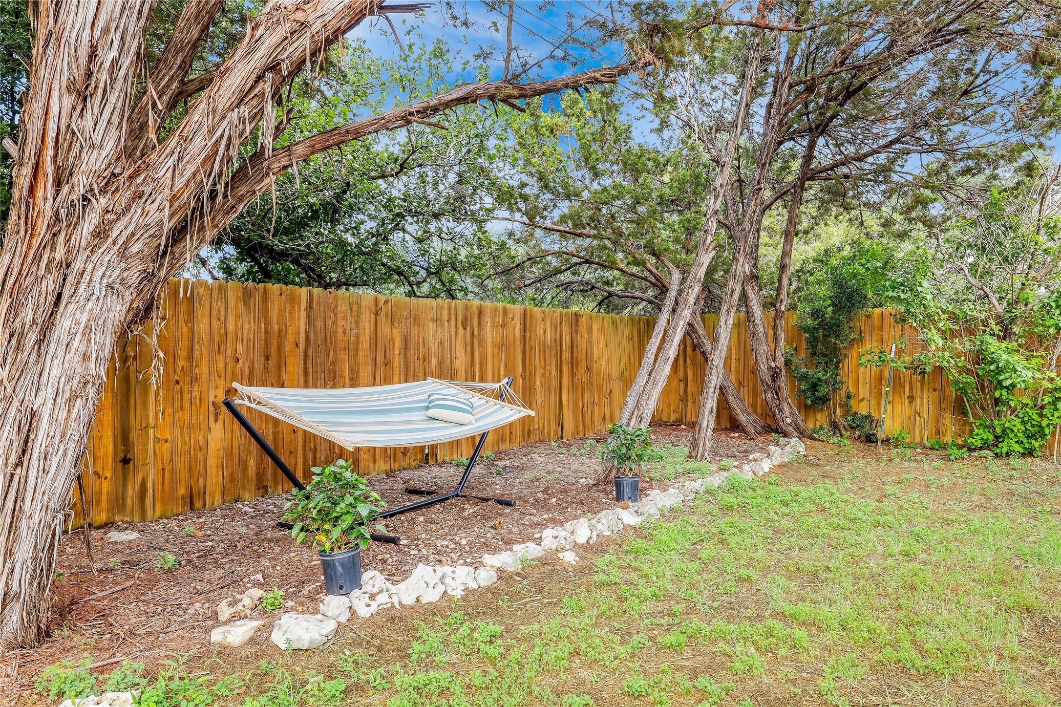 426 Summit Ridge Drive North Point Venture, TX 78645 - Photo 25 of 28 a backyard of a house with table and chairs