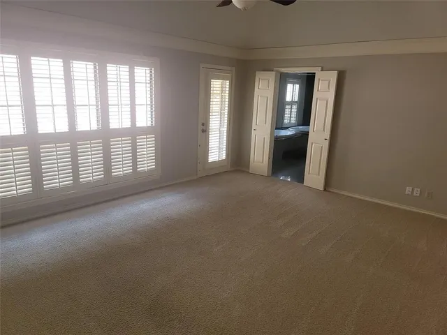 a view of a big room with windows and chandelier