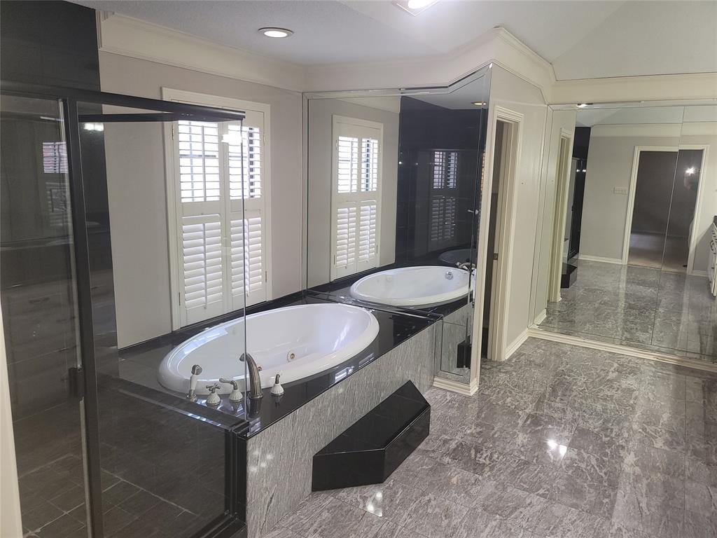 5719 Encore Drive Dallas, TX 75240 - Photo 14 of 21 a spacious bathroom with a granite countertop sink a toilet and shower