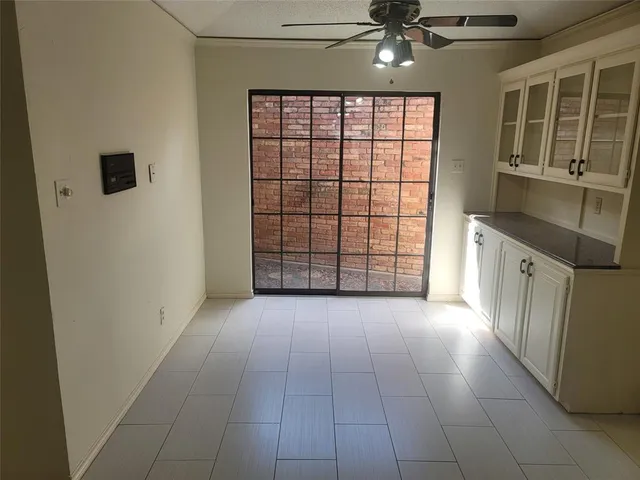 a view of a kitchen with an empty space and a window
